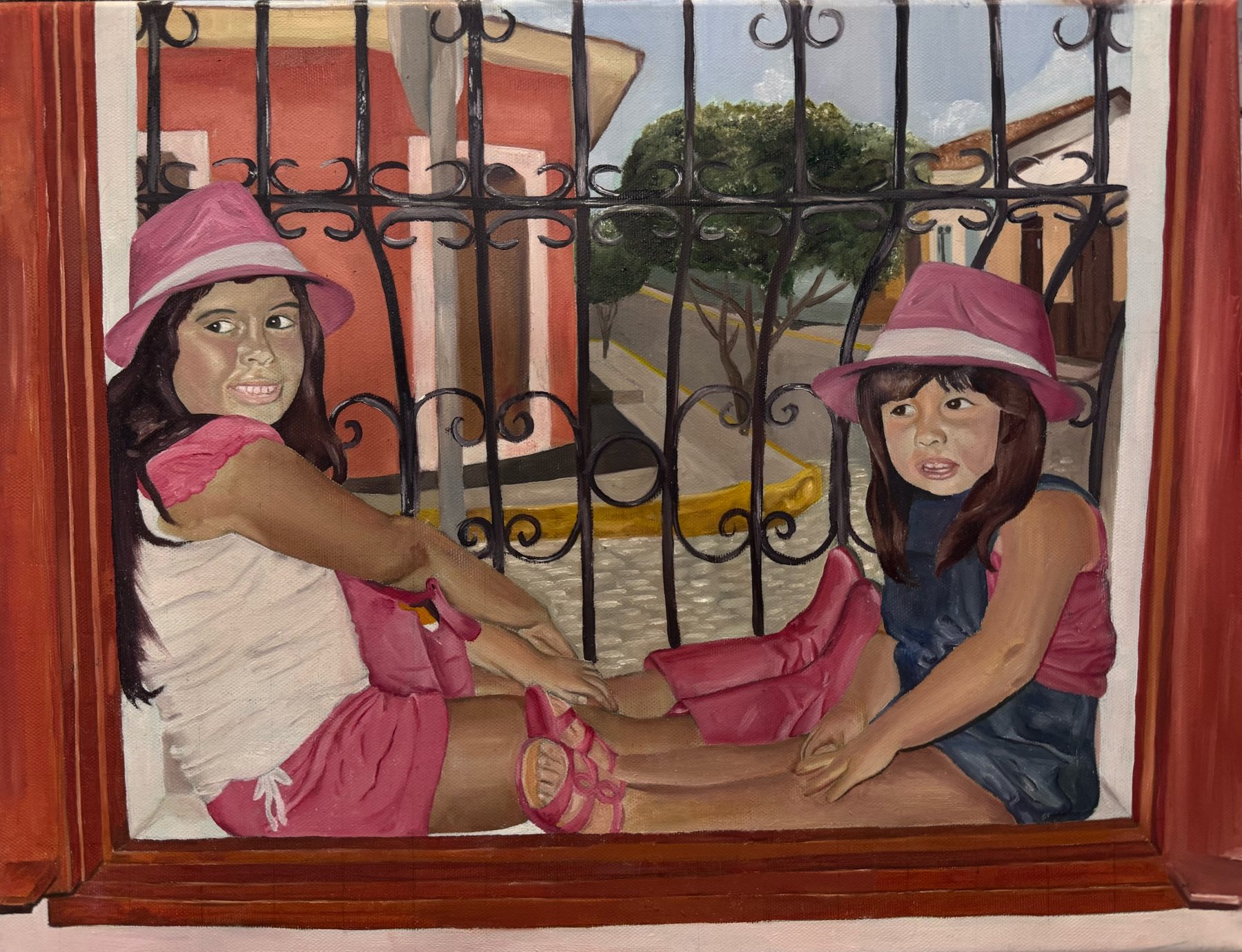 Painting of two young girls in pink hats sitting behind a wrought-iron balcony railing above a sunny street.