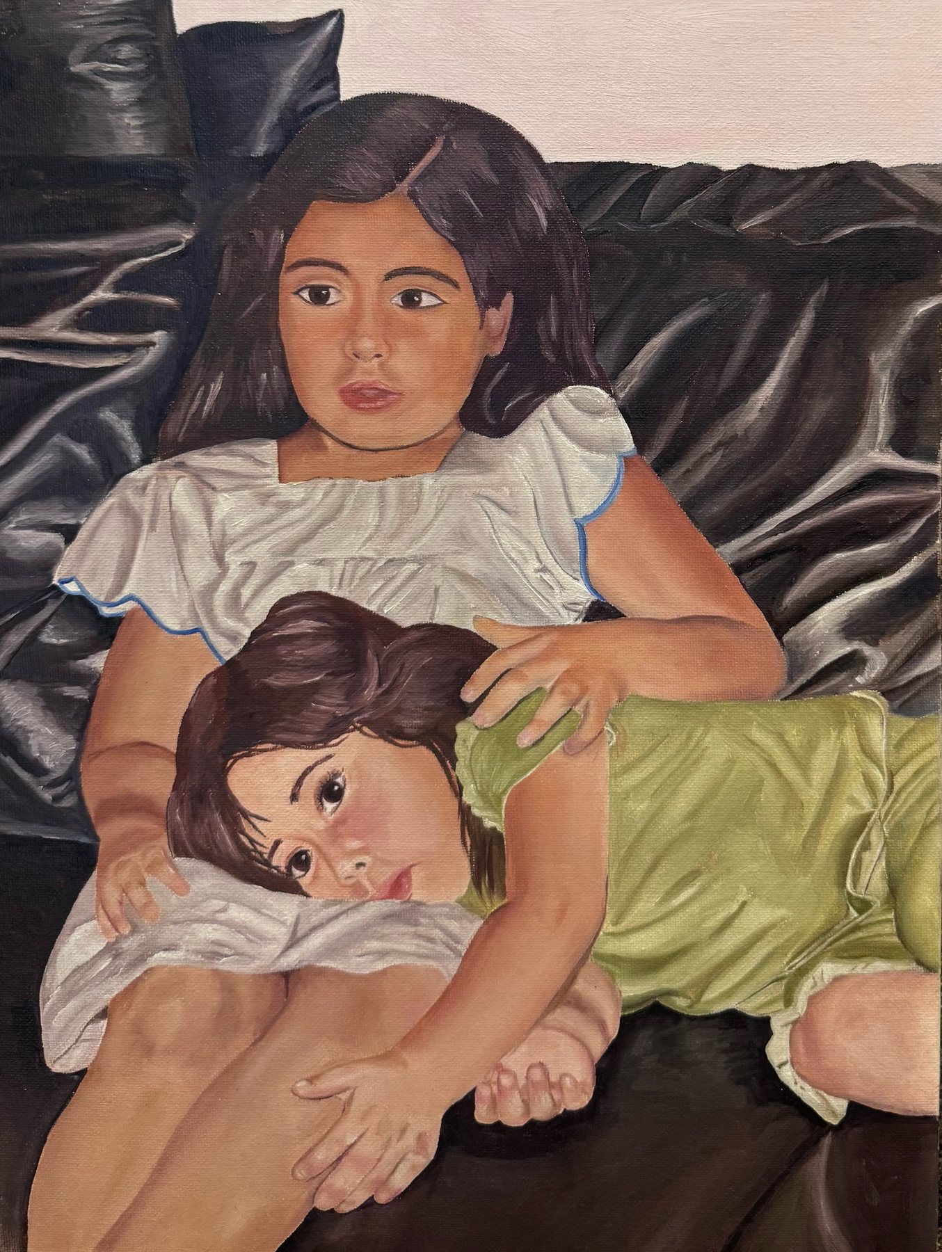 Painting of two young girls resting together on a dark leather couch, the younger lying across the older one’s lap.